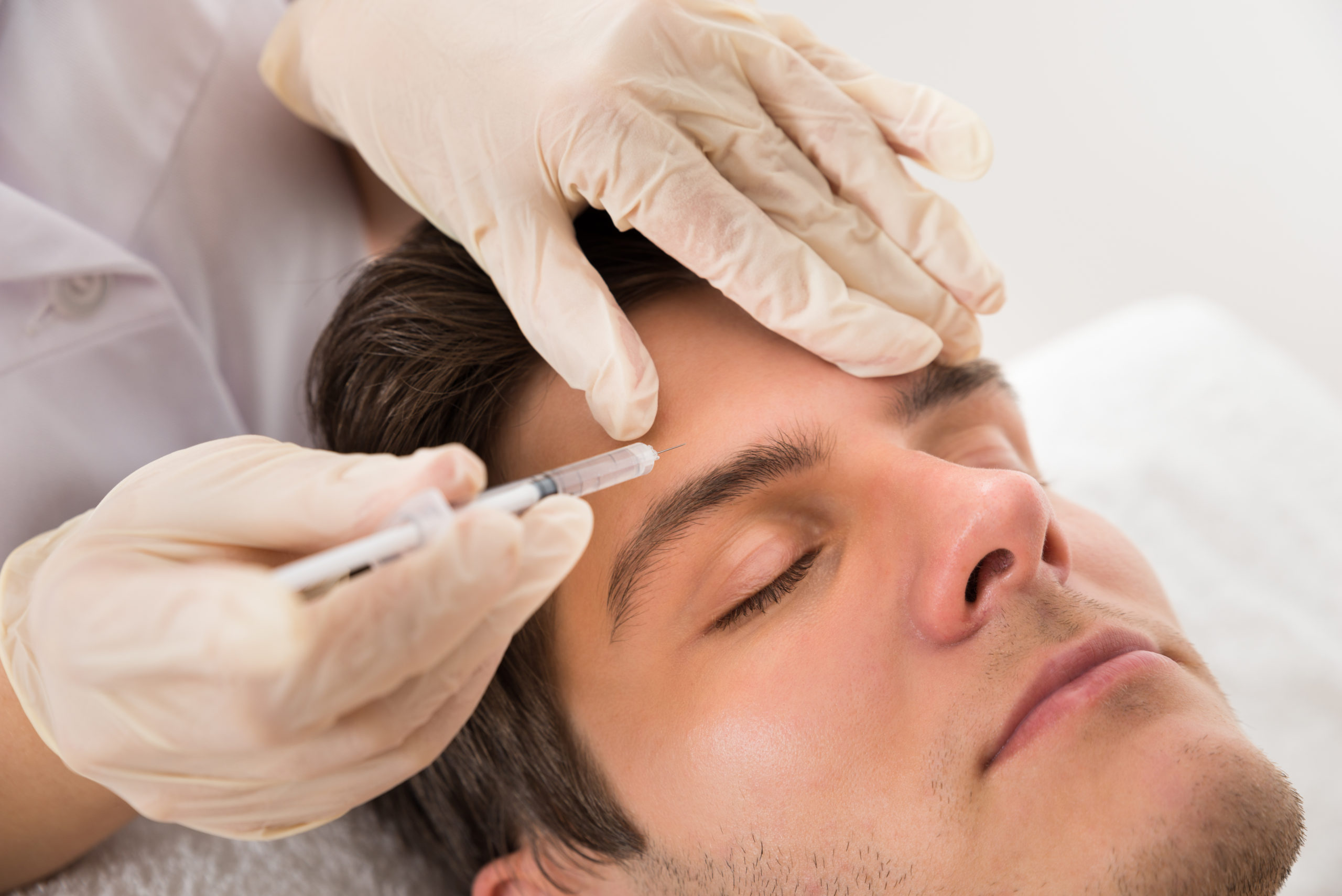 man receiving botox treatment