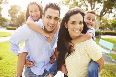 family of four smiling